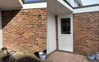 REHAU uPVC side door installed in garage - external view