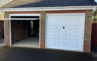 Before converting two garage door openings into one - two white single garage door