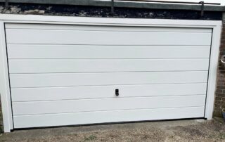 Manual Hormann sectional garage door in white woodgrain
