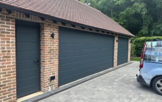 Two Hörmann sectional garage doors with matching side door