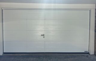 Closed side-opening pedestrian door in double garage door